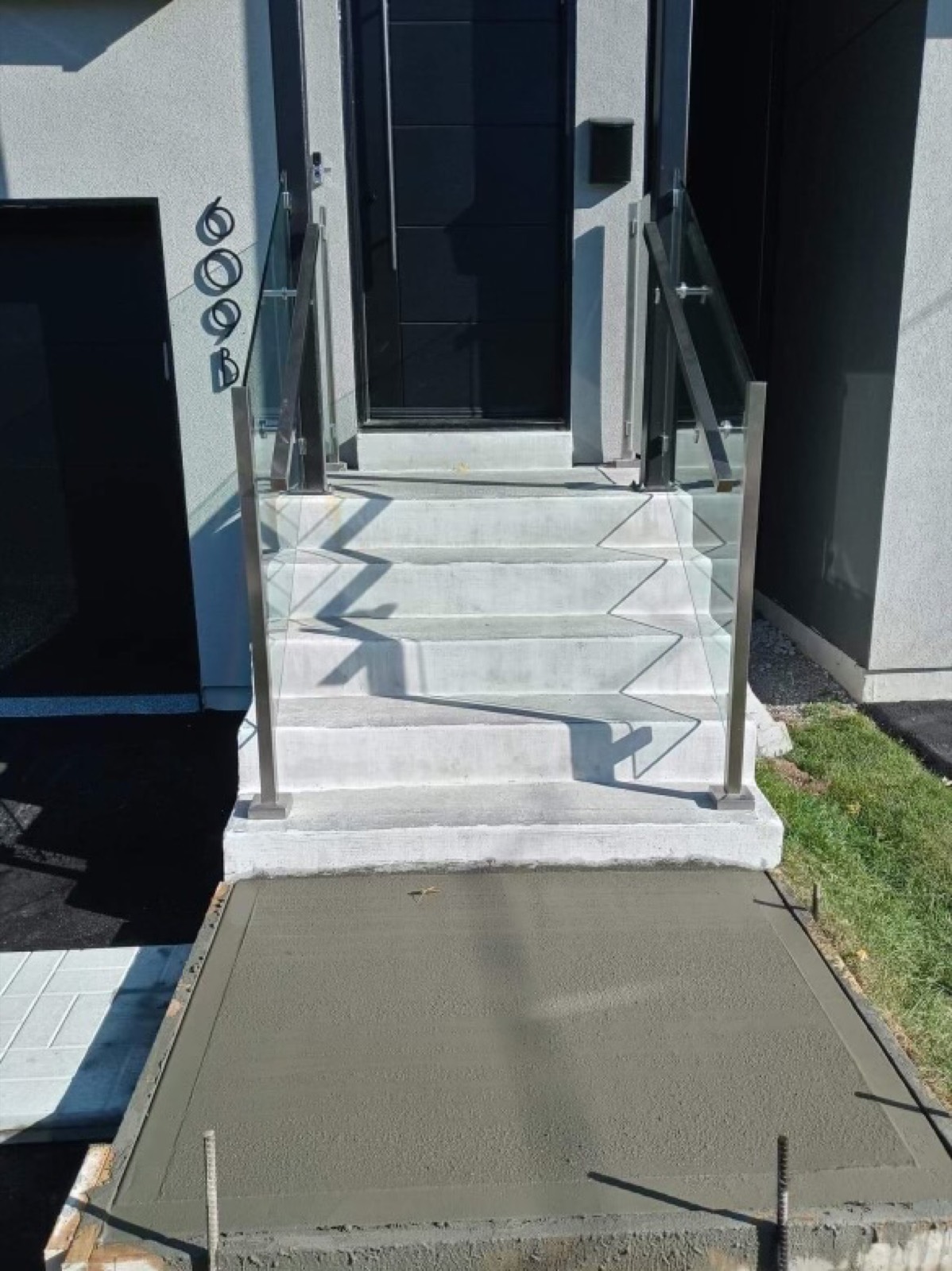 Fresh concrete slab and steps at a front entrance