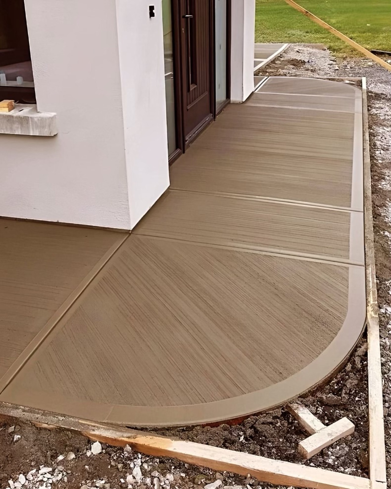 Curved broom-finish concrete walkway at a front entrance
